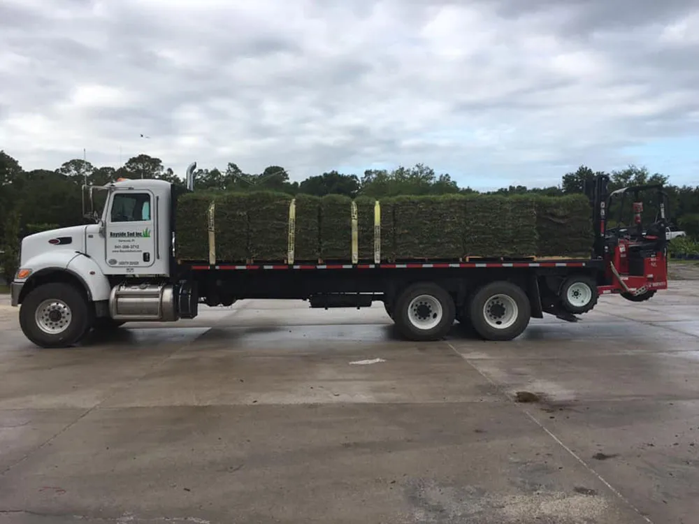 Flatbed truck loaded with pallets of fresh sod